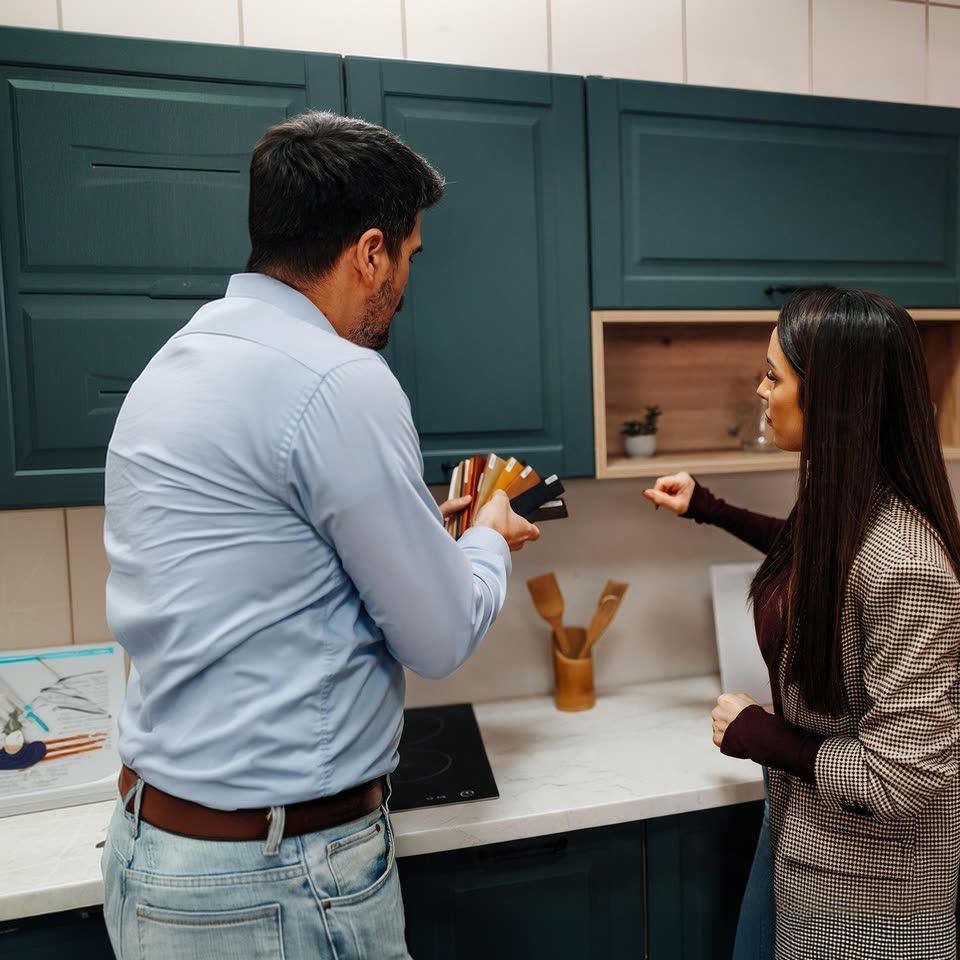 Client and designer comparing cabinet finish samples in a kitchen